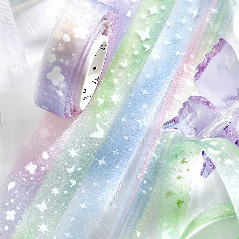 Pastel blue and green washi tapes with glittery star butterfly and music note patterns on translucent material