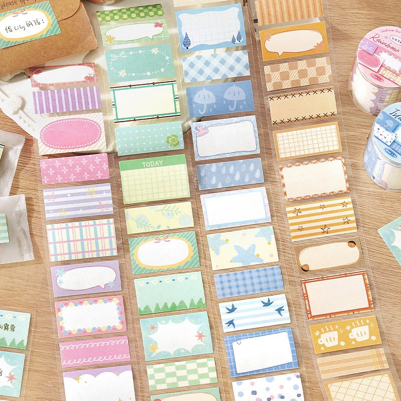 Assorted colorful adhesive label stickers with pastel patterns including plaid floral and whimsical designs on a wooden surface