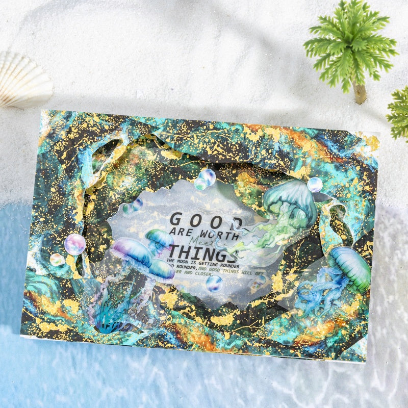 Vibrant holographic card with jellyfish art gold splatter accents and motivational text on a cosmic underwater design