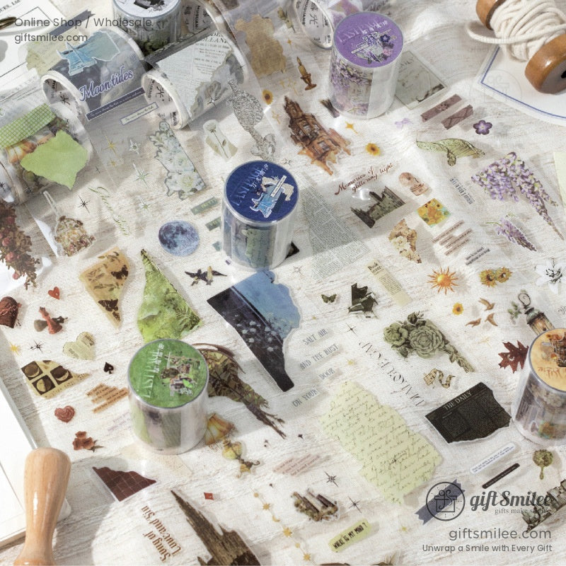 Assorted decorative washi tapes with pastel nature and vintage patterns on a light fabric surface