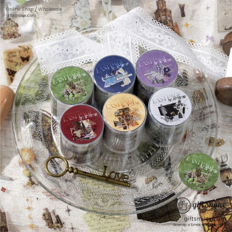 Vintagethemed washi tape set with colorful illustrations on metallic tins displayed on a glass plate with lace accents