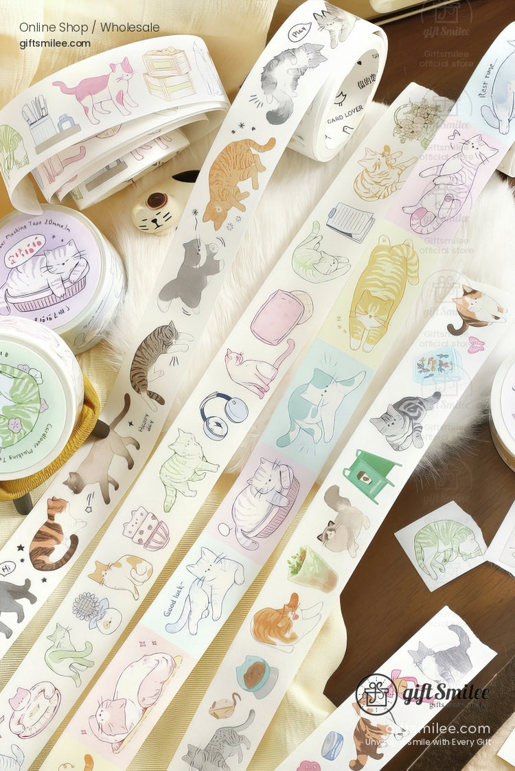 Pastelcolored catthemed washi tape rolls with playful illustrations of cats accessories and cozy items on a wood surface