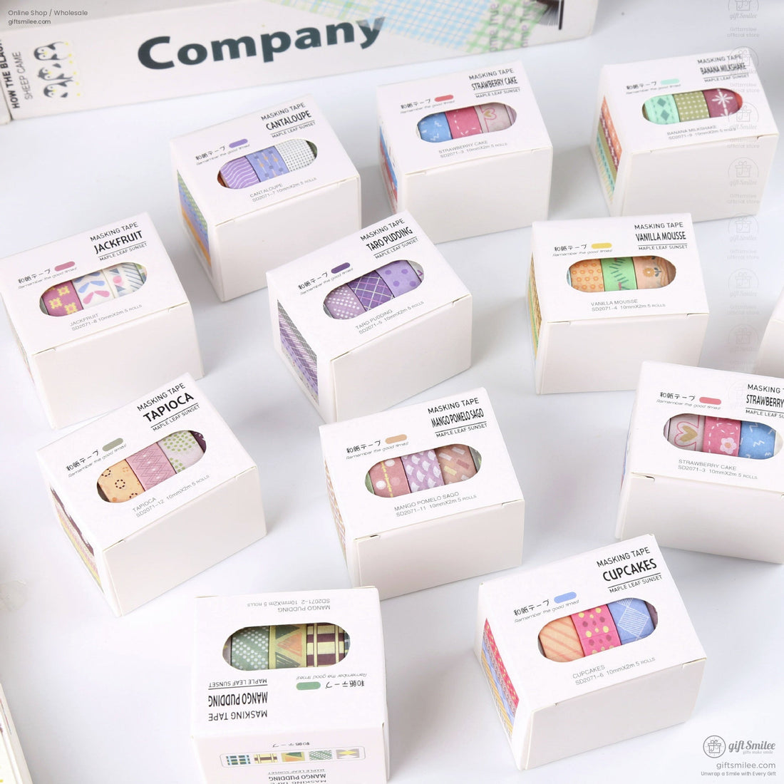 Assorted decorative masking tape sets in colorful patterns packaged in white boxes with clear windows and pastel designs