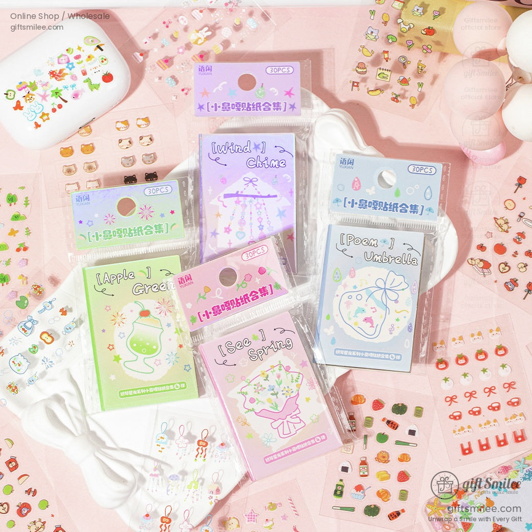 A set of colorful kawaii-themed stickers featuring animals, flowers, and decorations displayed on a pink surface