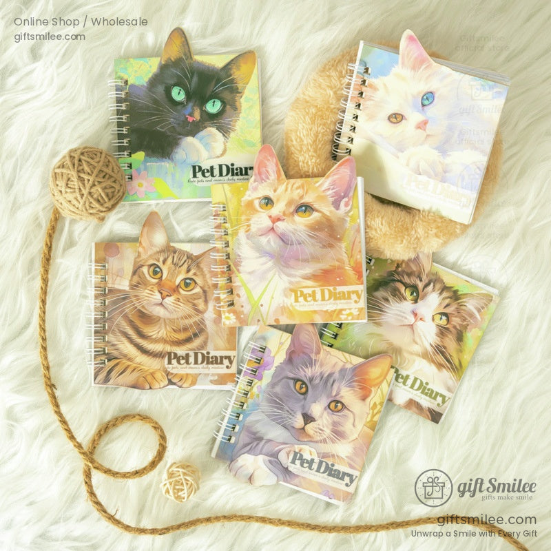 A collection of spiral-bound cat-themed journals featuring vibrant cat illustrations on a cozy white fur background