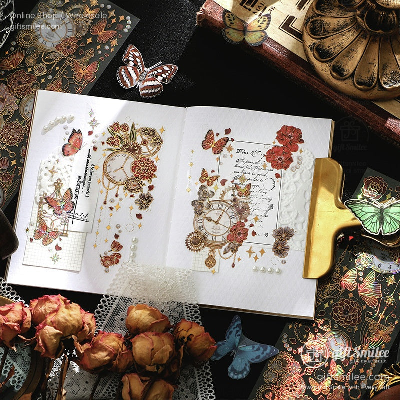 Vintage butterfly and floral scrapbook journal spread with gold clock stickers and lace accents on a dark desk