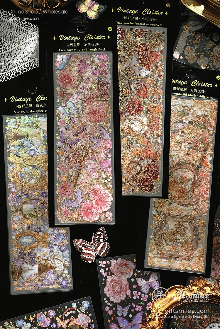 Vintage floral and butterfly gold-foil sticker sheets for scrapbooking and journaling, assorted designs on black background.