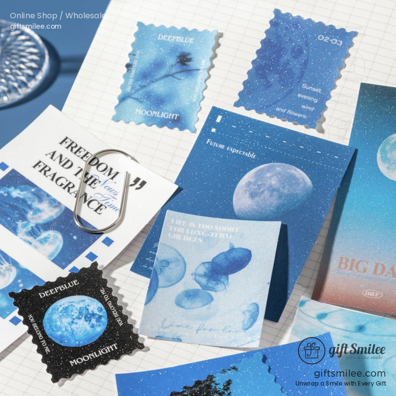 Assorted blue stationery sets with moon floral and butterfly designs featuring stamps cards and decorative elements