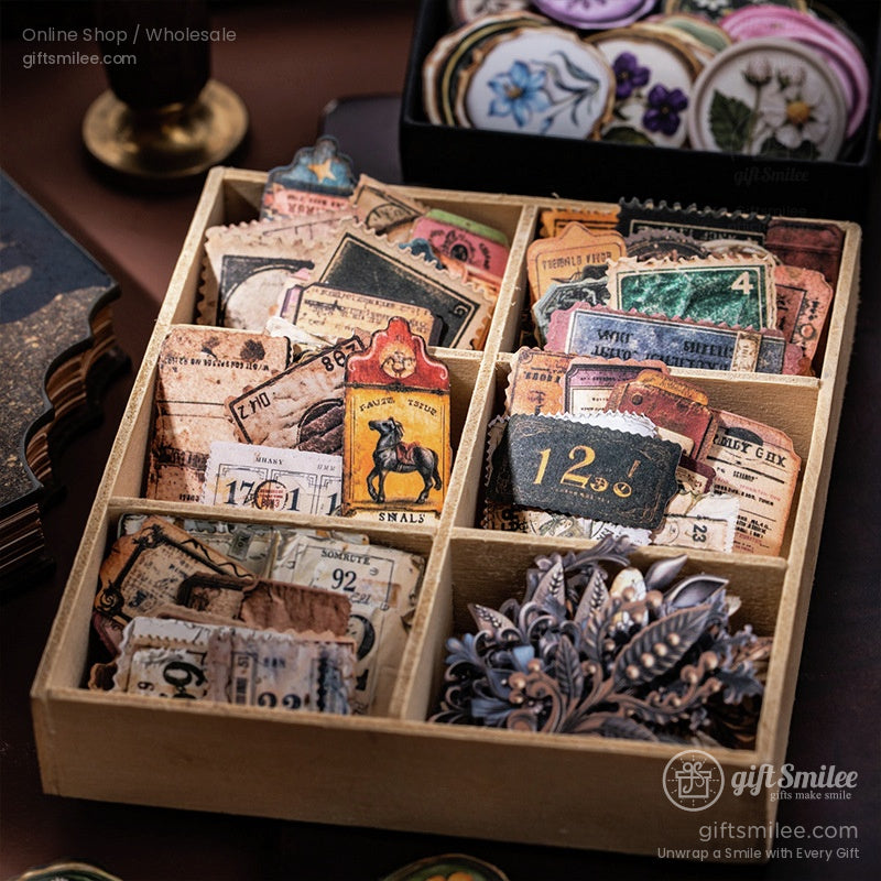 Vintagestyle paper ephemera set in a wooden organizer featuring retro tickets floral stickers and intricate diecuts