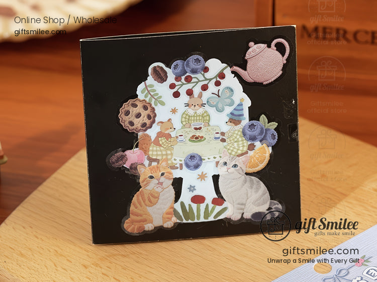 Black wooden coaster with colorful cat illustrations tea party design berries teapot and playful floral accents