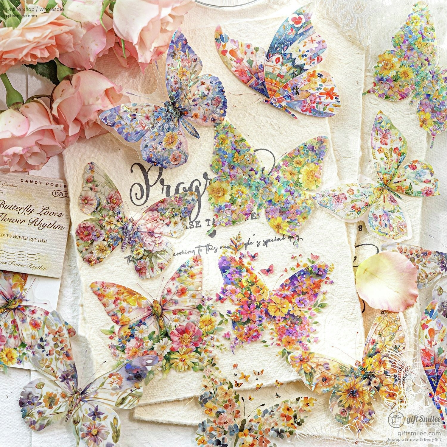 Vibrant floralpatterned butterfly stickers on textured beige paper surrounded by pink roses and delicate lace accents
