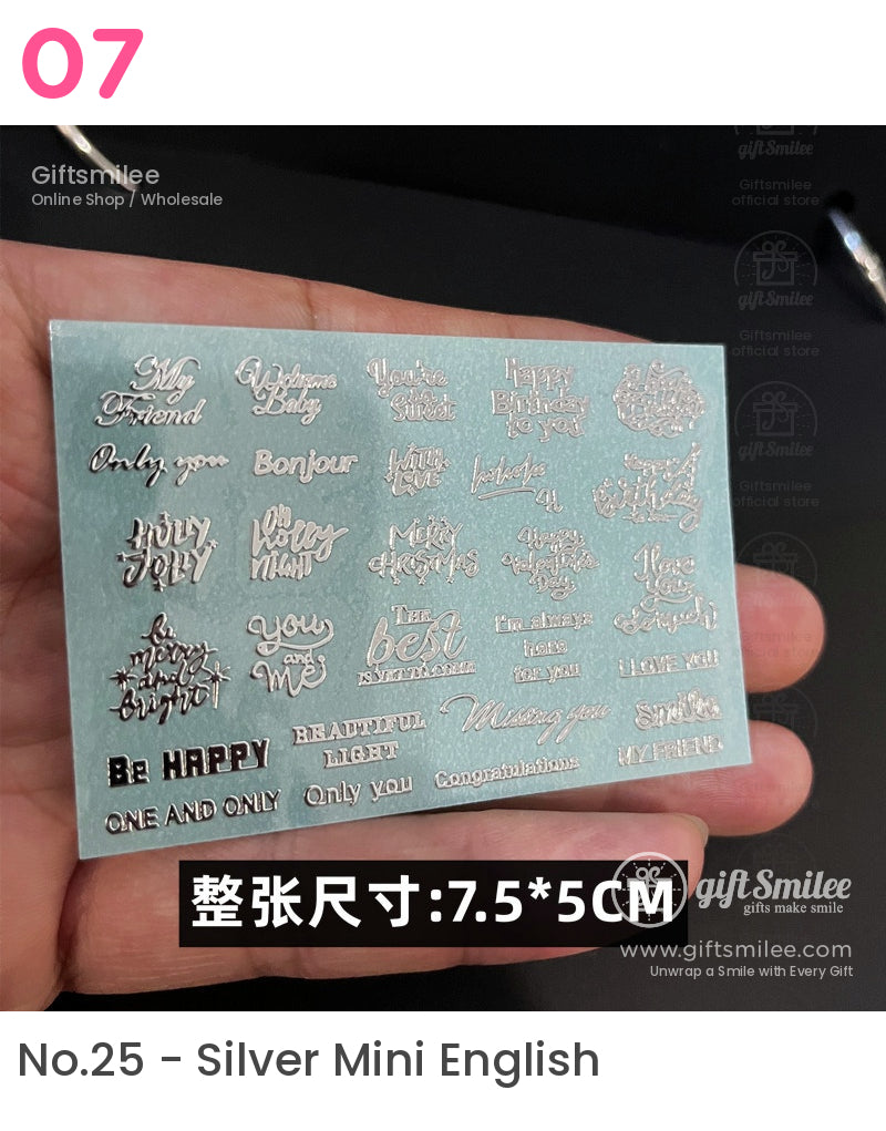 Sheet of silver metallic phrase stickers on blue backing featuring various greetings and affirmations in elegant fonts