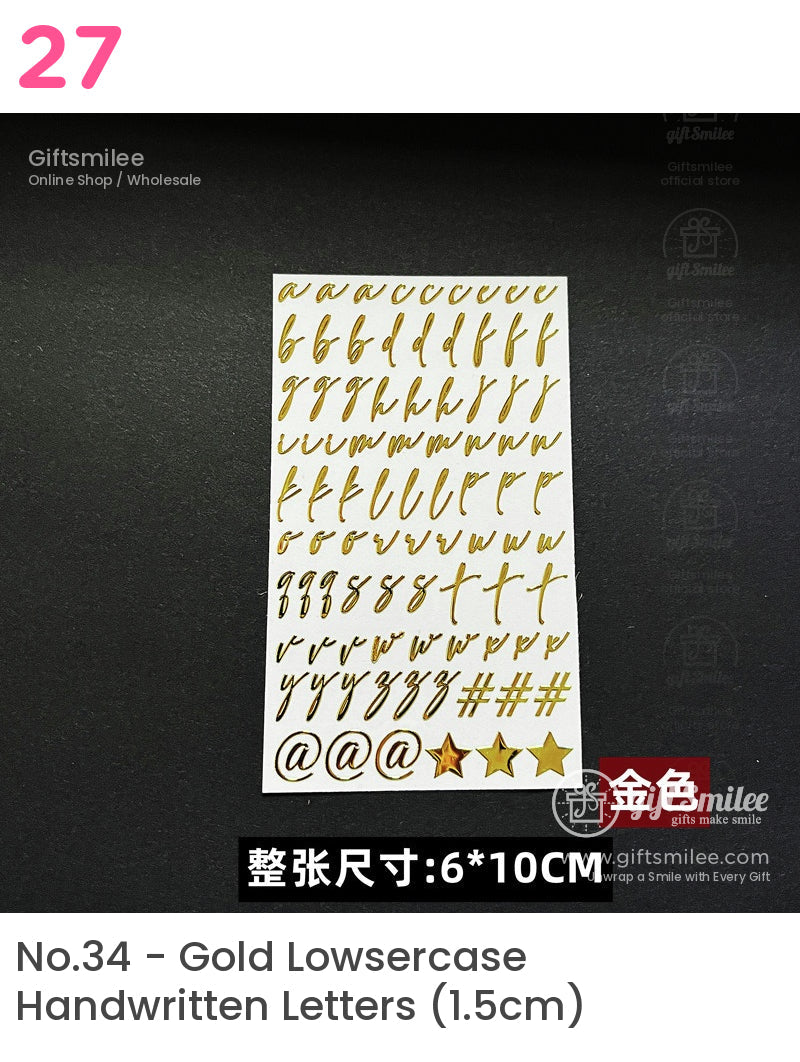 Gold cursive alphabet and symbol stickers on white sheet 6x10cm size suitable for crafts or decorative projects