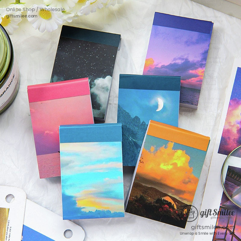 Colorful pocketsized notebooks with scenic skythemed covers featuring vibrant sunsets starry nights and cloudy skies