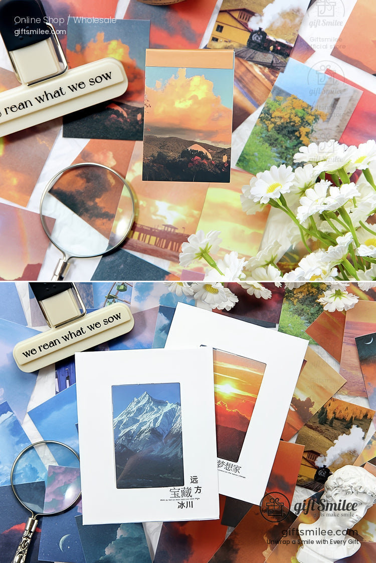 Assorted landscape postcards with vibrant colors magnifying glass white flowers and aesthetic desk accessories