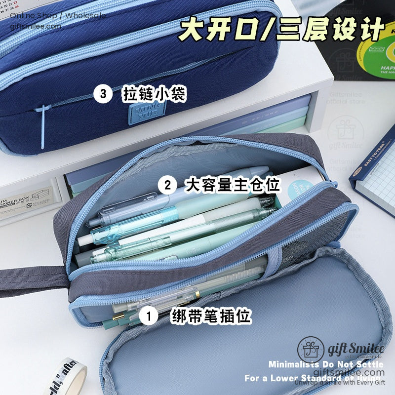 Open view of the multi-compartment pencil case featuring pens and stationery