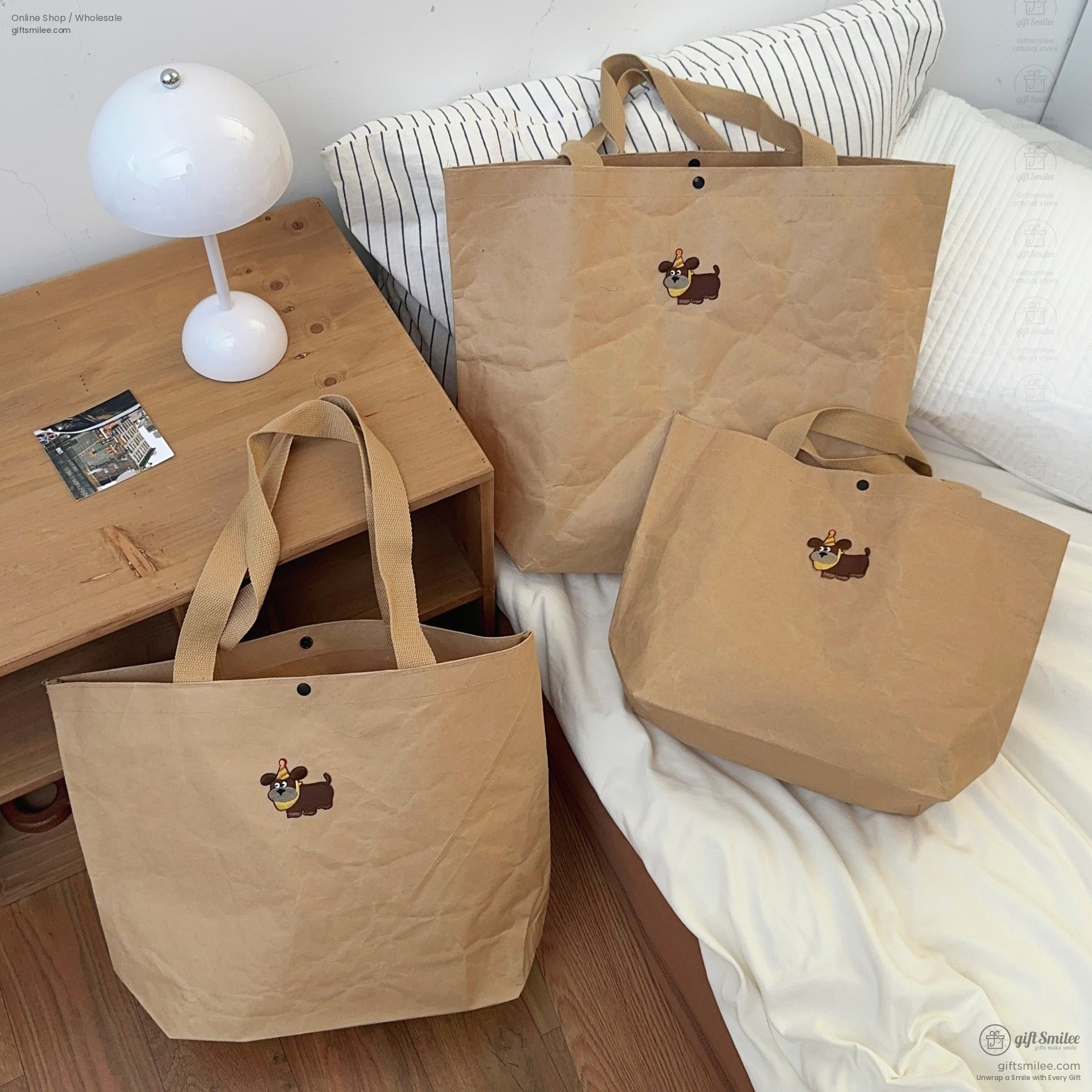 Set of three brown kraft paperstyle tote bags with sturdy beige straps and a cartoon dog print embellishment