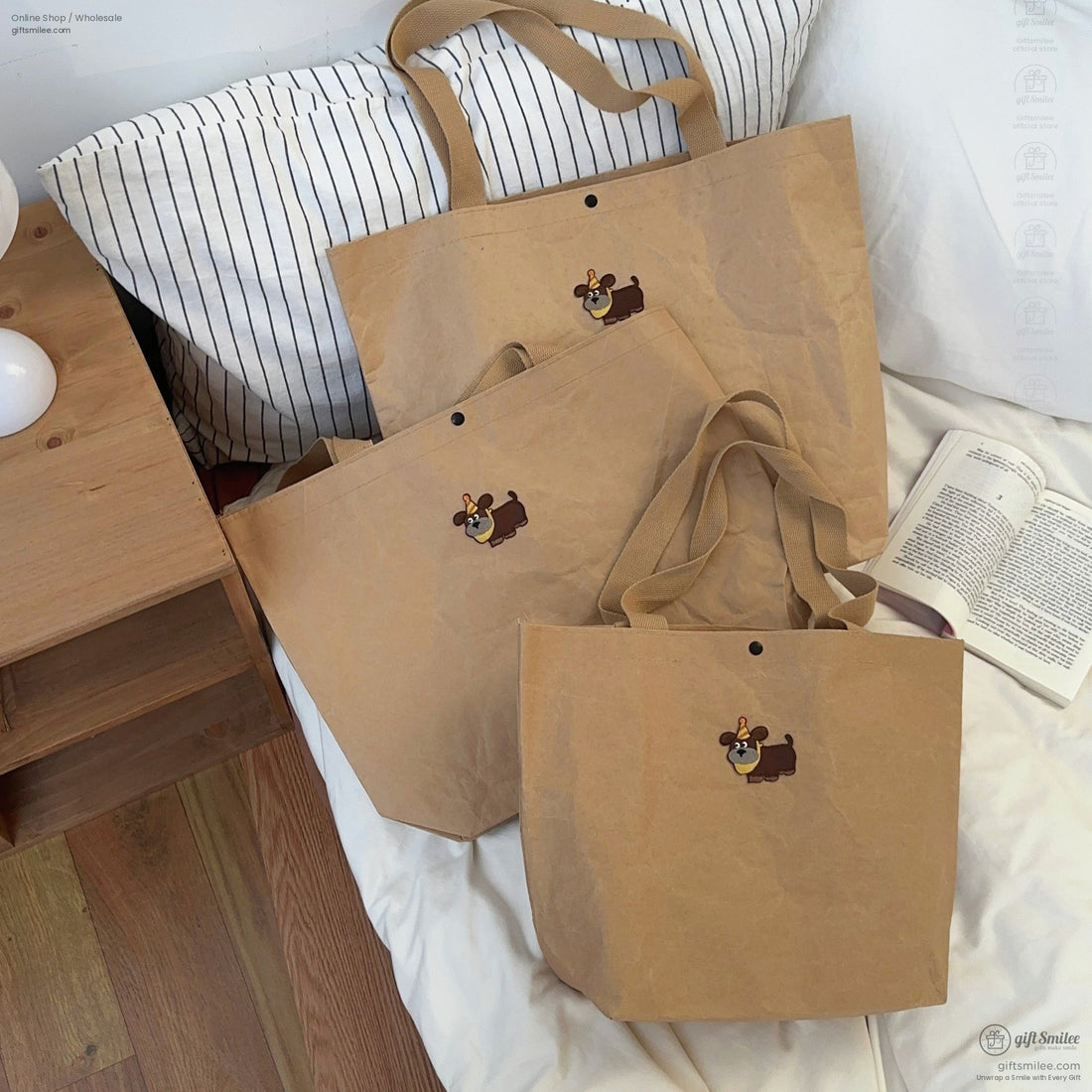 Set of three brown kraft paperstyle tote bags with sturdy beige straps and a cartoon dog print embellishment