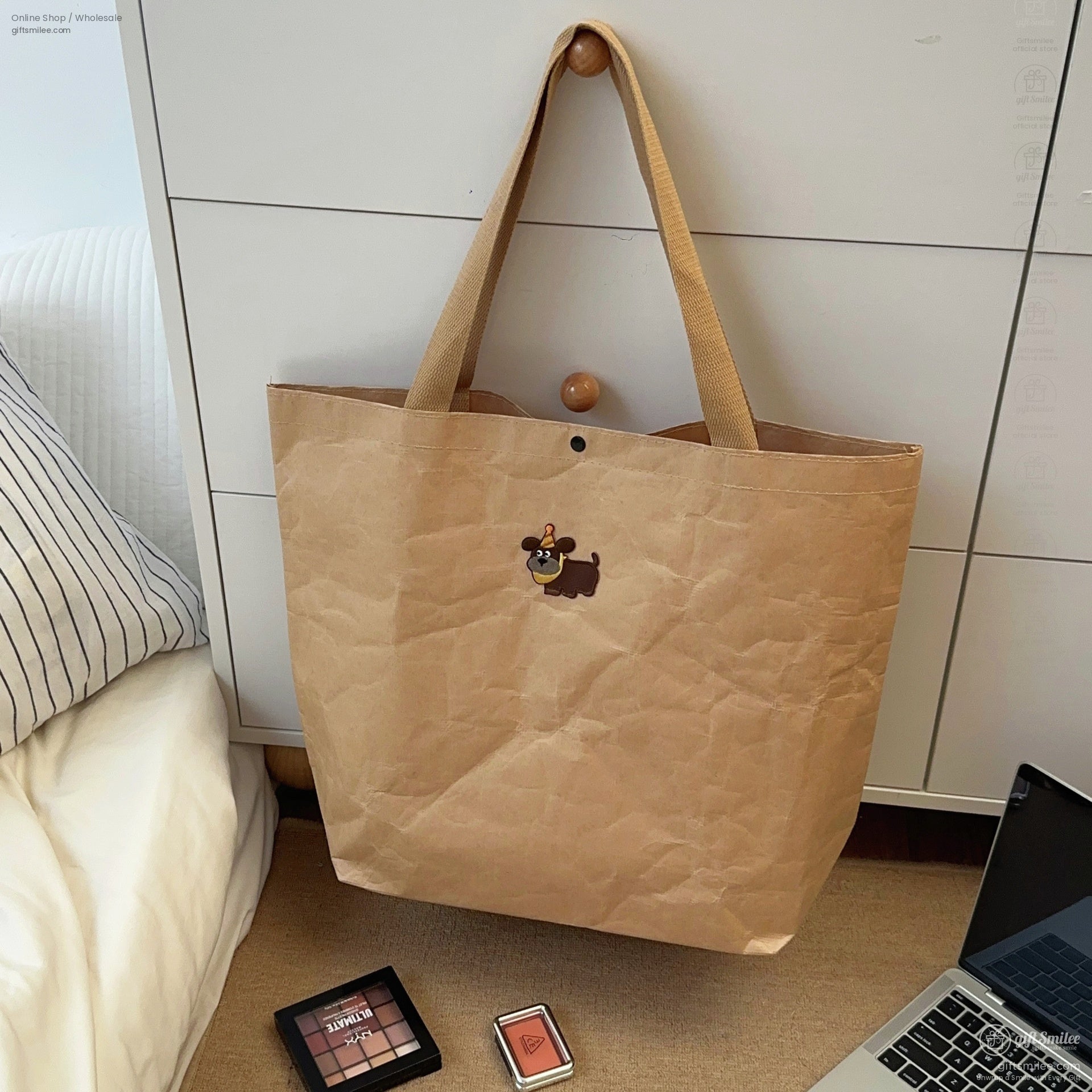 Large brown kraft paper tote bag with sturdy beige handles and a playful cartoon dog patch detail