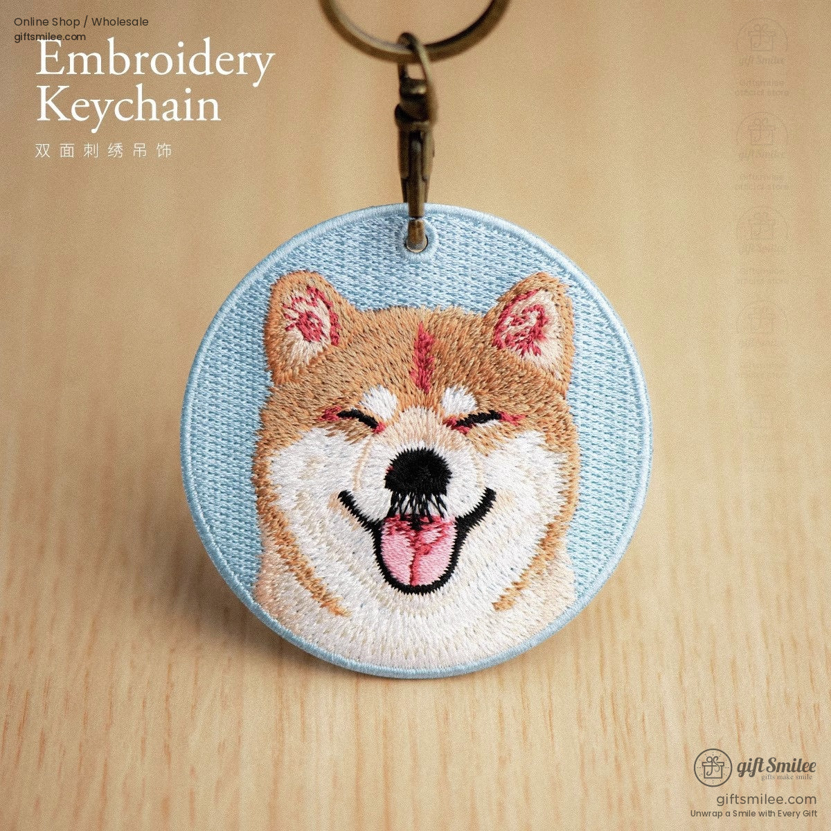 Round light blue embroidered keychain with smiling Shiba Inu design detailed stitching and bronze keyring