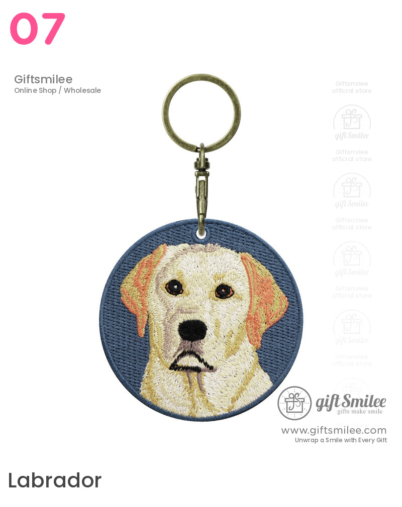 Round blue fabric keychain with detailed embroidered Labrador retriever design and antique brass keyring clasp