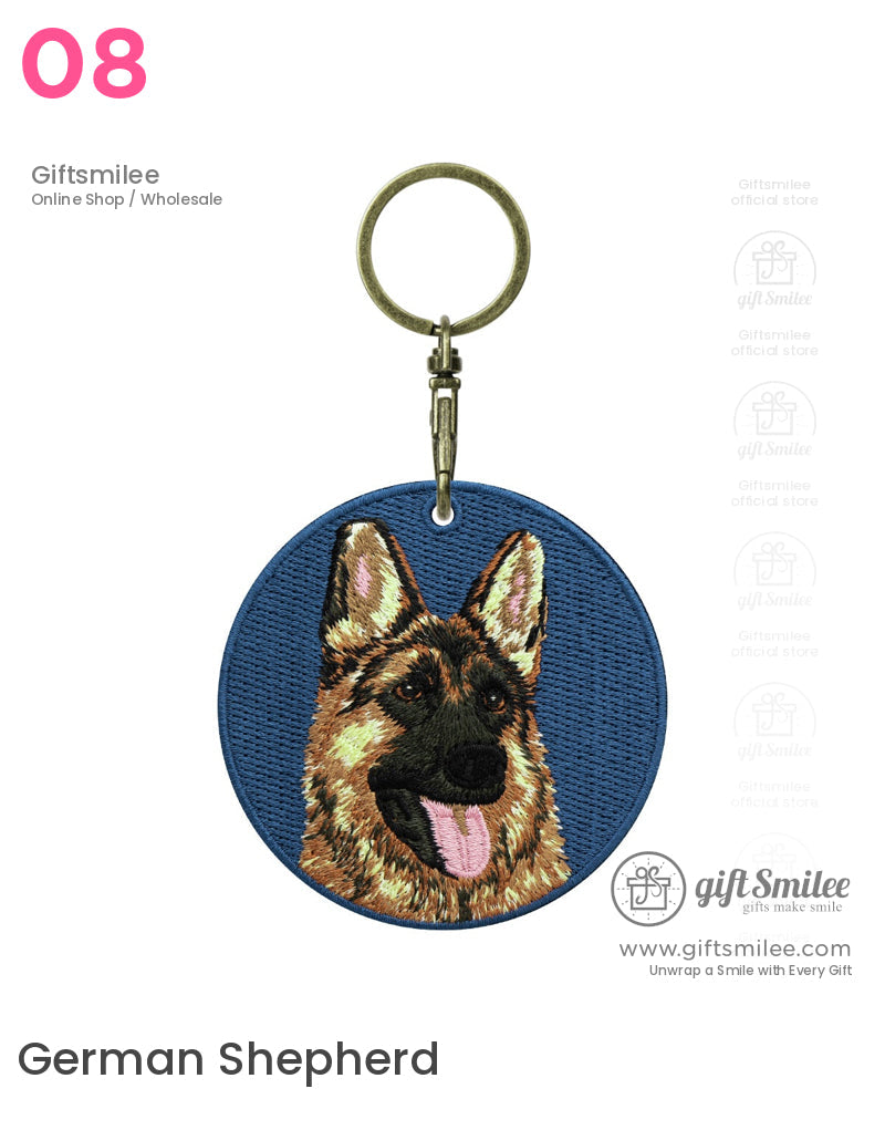 Round blue fabric keychain with embroidered German Shepherd face detailed fur texture and attached brass keyring