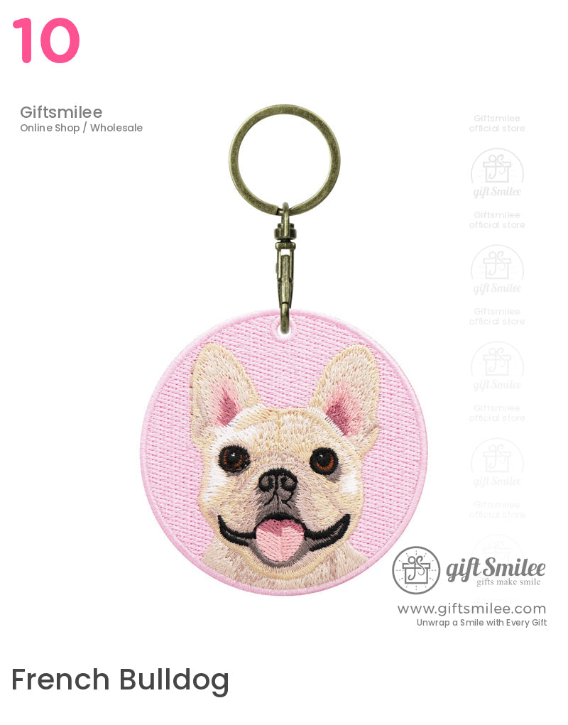 Round pink keychain with embroidered French bulldog face metal clasp and textured pastel fabric
