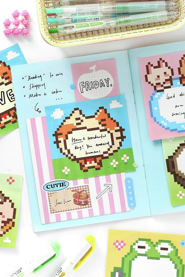 Pastel blue journal with pixel art animal stickers handwritten notes striped accents and vibrant highlighter pens
