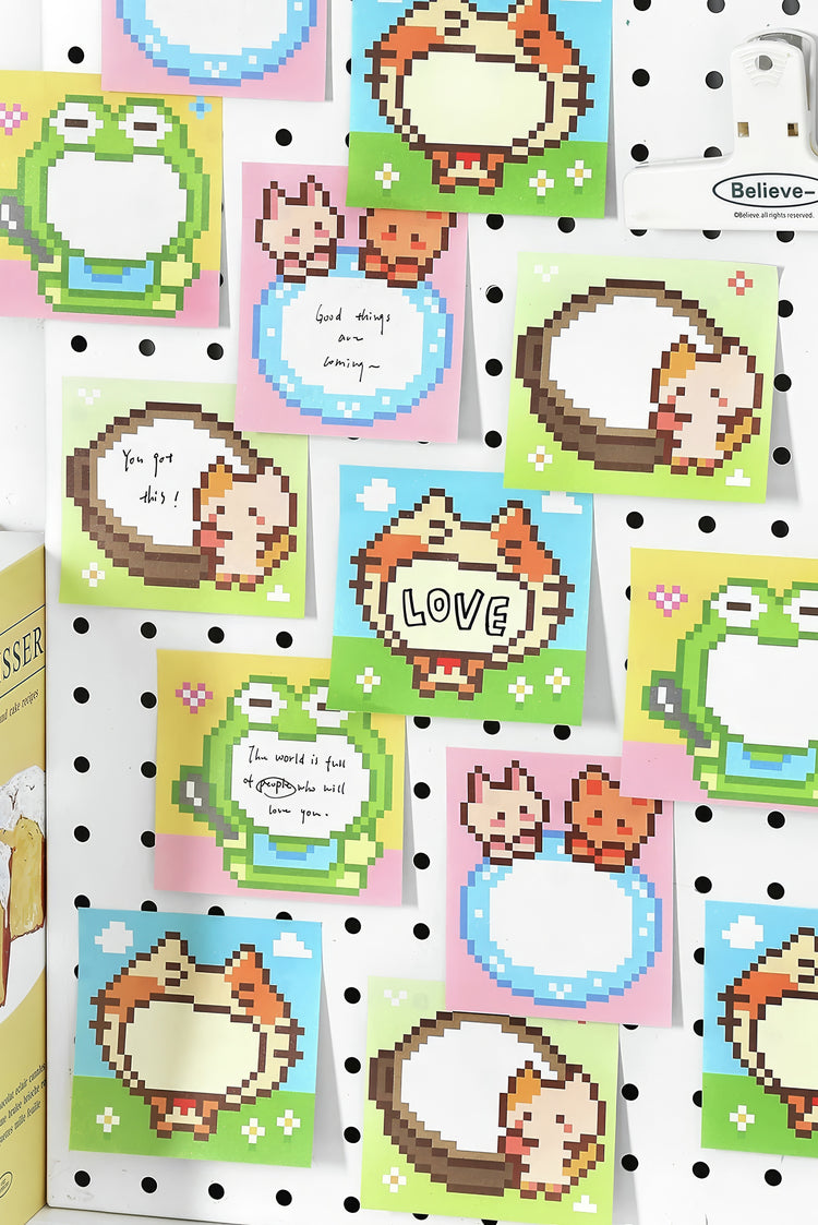 Colorful pixel art sticky notes with cats frogs and speech bubbles in pastel shades on a white pegboard background