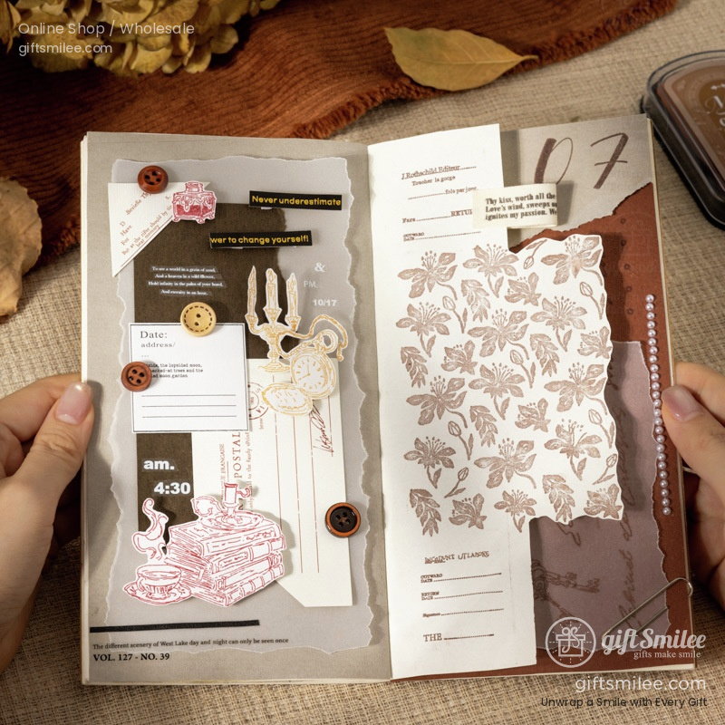 Vintagestyle scrapbook with floral patterns layered paper designs buttons clock and candelabra stickers on beige fabric