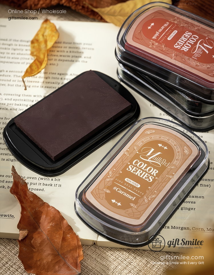Rectangular caramel brown ink pad in a compact cleartop case paired with dark brown pigment block on a rustic backdrop