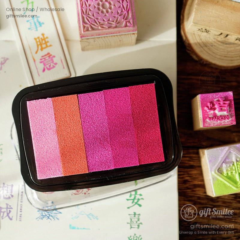 Multicolor gradient ink pad featuring vibrant pink magenta and orange tones in a rectangular black plastic case