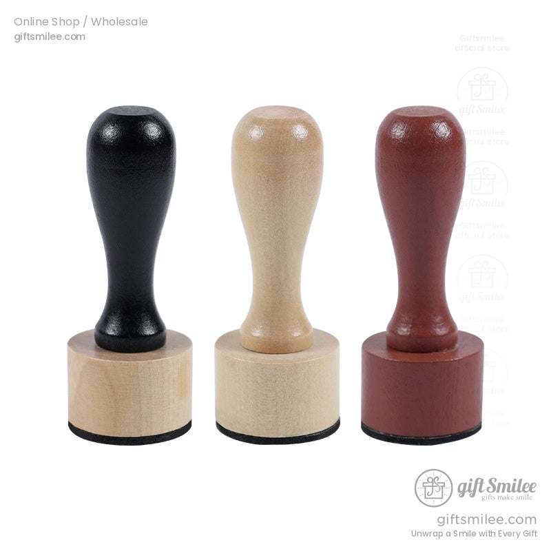 Set of three wooden stamp handles in black natural beige and mahogany brown finishes with smooth ergonomic grips